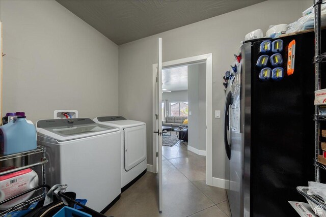 washroom with laundry area, baseboards, and separate washer and dryer