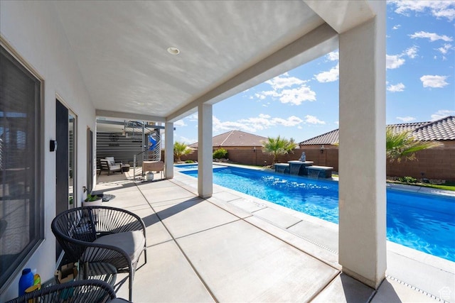 view of pool featuring a patio, a fenced backyard, and a fenced in pool