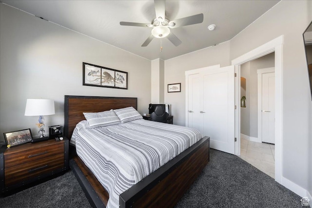 bedroom featuring tile patterned flooring, carpet, baseboards, and a ceiling fan