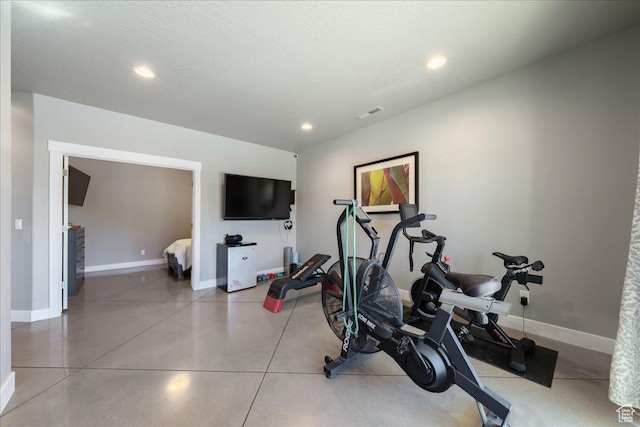 exercise room with a textured ceiling, recessed lighting, and baseboards