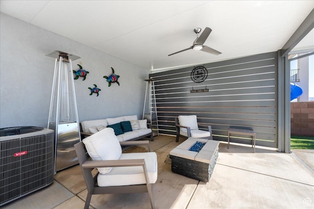 view of patio / terrace with an outdoor living space with a fire pit, central AC, and ceiling fan