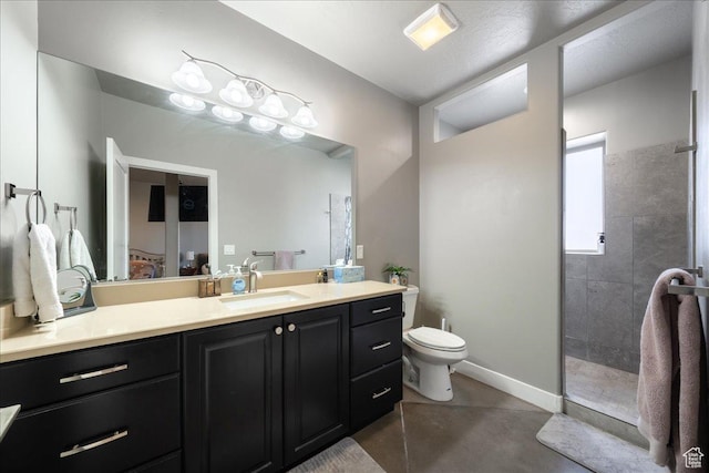 full bath with toilet, baseboards, a walk in shower, and vanity