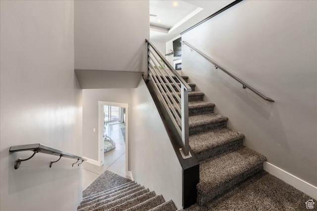 staircase featuring baseboards