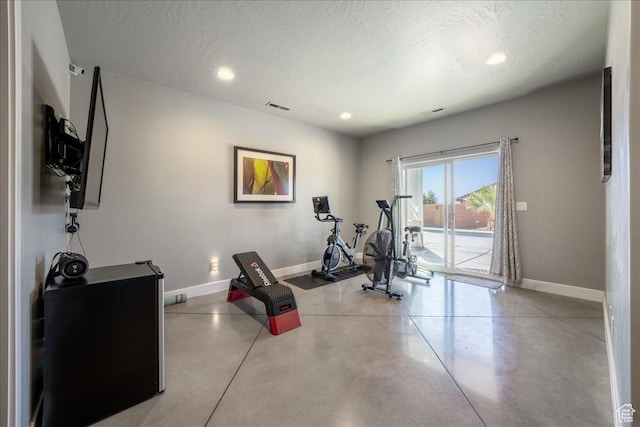 workout area featuring recessed lighting, visible vents, a textured ceiling, and baseboards