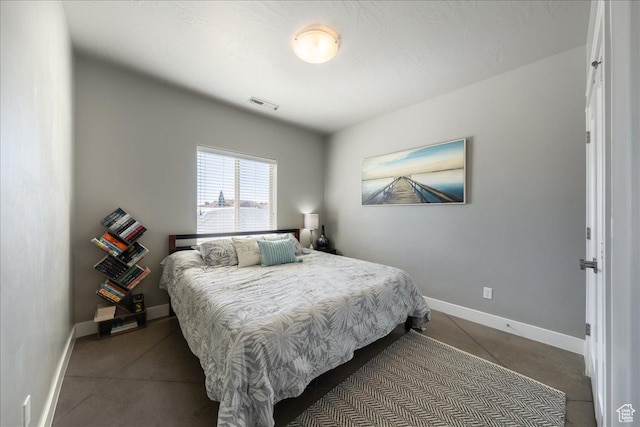 bedroom with baseboards and visible vents