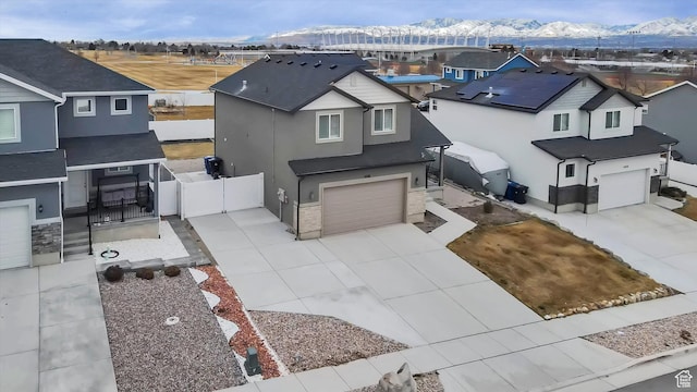 traditional home with a residential view, a gate, and driveway