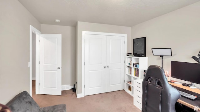 office space with light carpet, visible vents, and baseboards