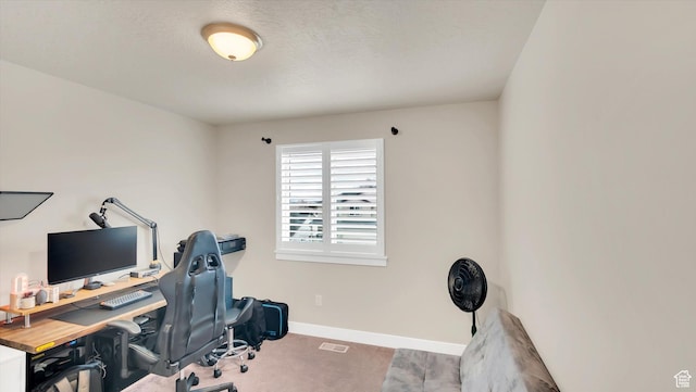 office area with a textured ceiling, carpet floors, and baseboards