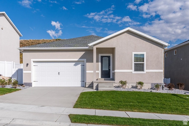 single story home with stucco siding, concrete driveway, an attached garage, a front yard, and fence