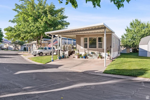 1160 E Telegraph St Unit 220, Washington, UT 84780 - manufactured / mobile home with a front lawn and a carport