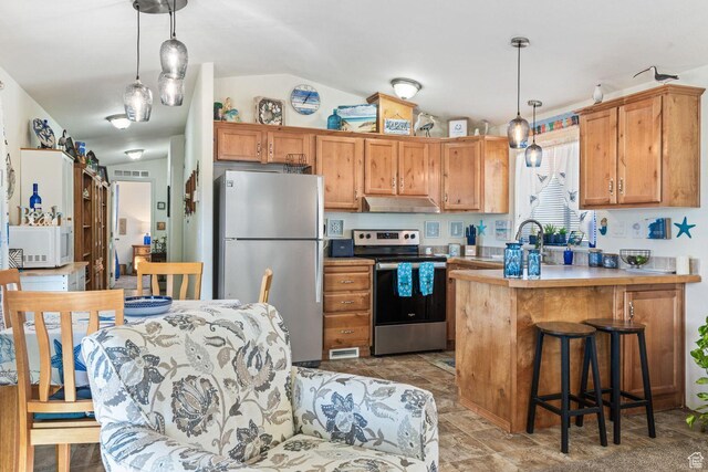 1160 E Telegraph St Unit 220, Washington, UT 84780 - kitchen with appliances with stainless steel finishes, under cabinet range hood, lofted ceiling, a peninsula, and pendant lighting
