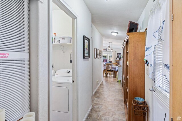 1160 E Telegraph St Unit 220, Washington, UT 84780 - hall featuring washer / clothes dryer, a heating unit, plenty of natural light, and baseboards