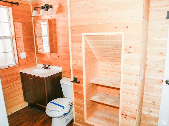 1290 Echo Crk Unit 2, Echo, UT 84024 - bathroom with toilet, wood walls, wood finished floors, and vanity