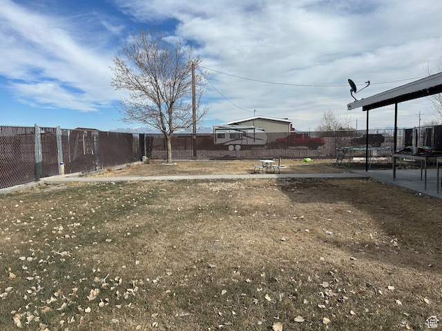 view of yard featuring a fenced backyard and a trampoline