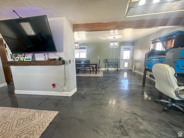 interior space with baseboards, concrete floors, and a textured ceiling