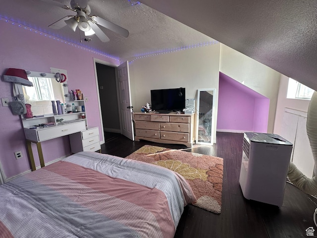 bedroom with baseboards, a textured ceiling, dark wood-style flooring, and multiple windows