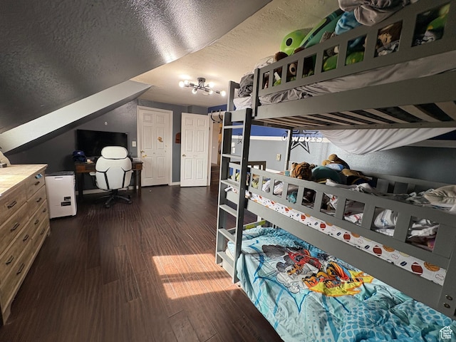 bedroom with dark wood-style flooring and a textured ceiling