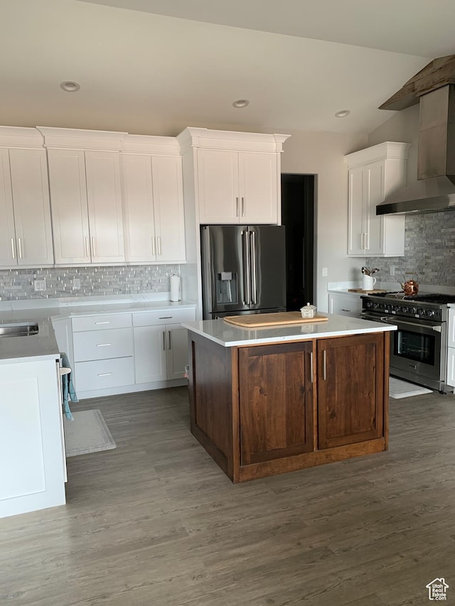 3606 E 375 S, Roosevelt, UT 84066 - kitchen featuring white cabinets, wall chimney exhaust hood, wood finished floors, a center island, and stainless steel appliances
