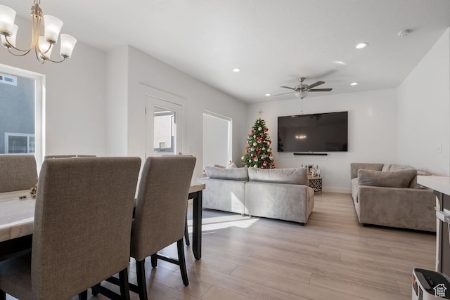4758 E Hidden Loop Rd, Eagle Mountain, UT 84005 - dining area featuring light wood-style flooring, recessed lighting, ceiling fan with notable chandelier, visible vents, and baseboards