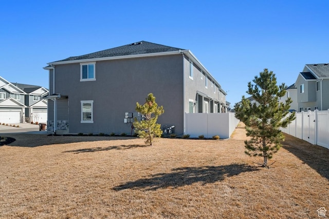 4758 E Hidden Loop Rd, Eagle Mountain, UT 84005 - view of side of home with fence and stucco siding