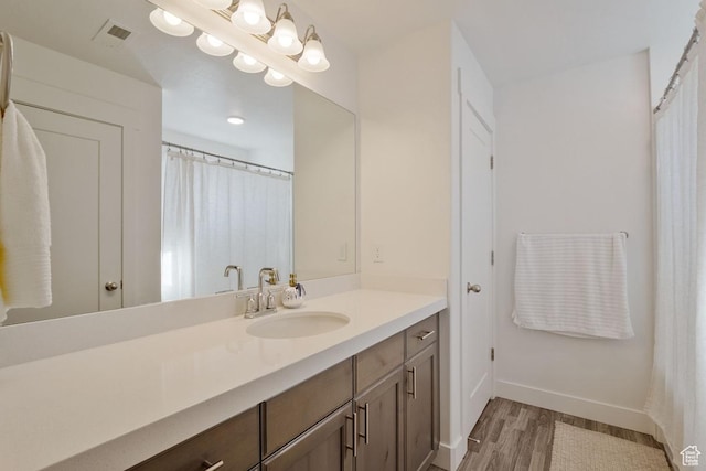 4758 E Hidden Loop Rd, Eagle Mountain, UT 84005 - full bath with baseboards, visible vents, wood finished floors, and vanity