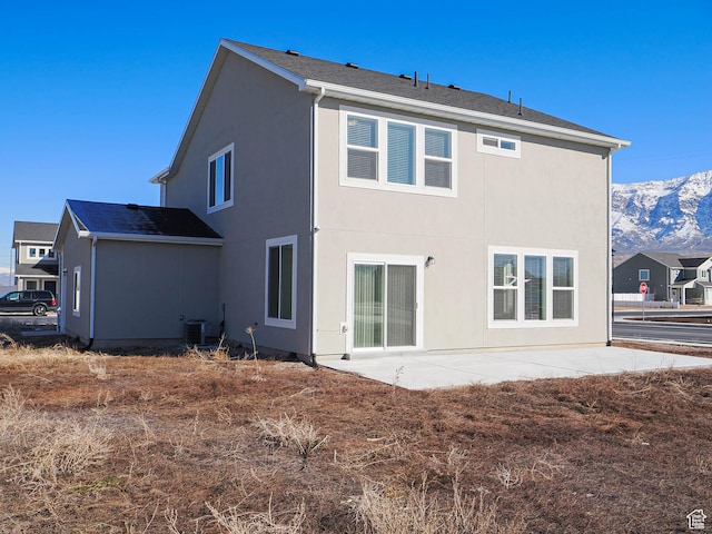 3361 W 3275 N, Plain City, UT 84404 - rear view of property featuring cooling unit, a mountain view, a patio, and stucco siding