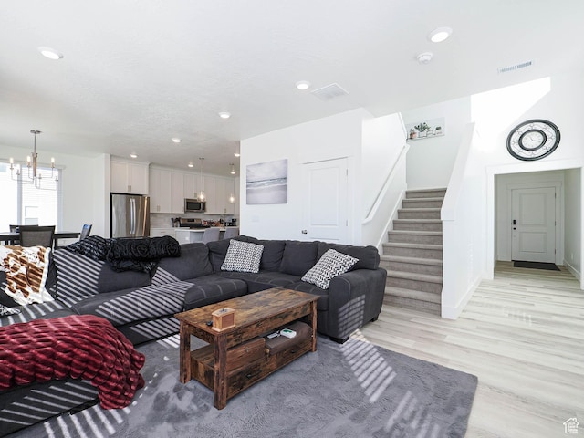 3361 W 3275 N, Plain City, UT 84404 - living room featuring a notable chandelier, recessed lighting, visible vents, light wood-style flooring, and stairs