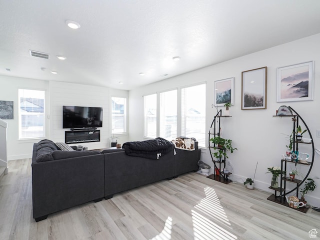 3361 W 3275 N, Plain City, UT 84404 - living room featuring light wood finished floors, baseboards, visible vents, and a wealth of natural light