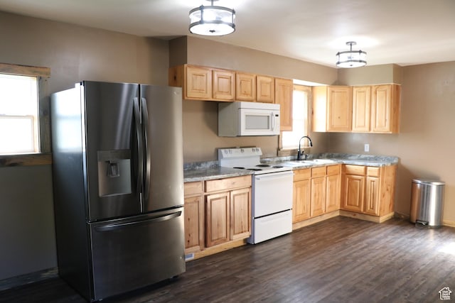 kitchen featuring white appliances, light brown cabinetry, a sink, and dark wood-style flooring
