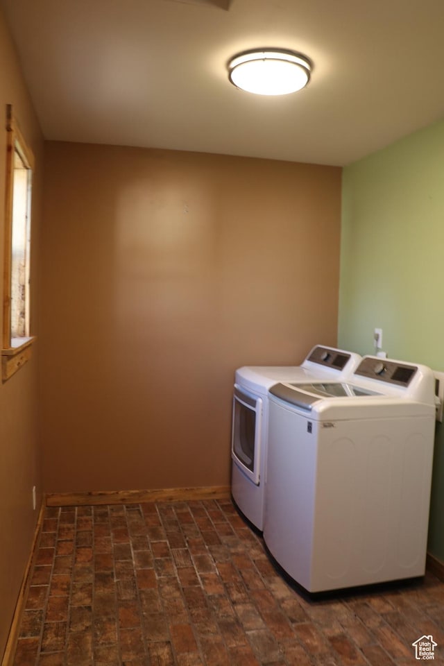 washroom featuring independent washer and dryer and brick patterned flooring