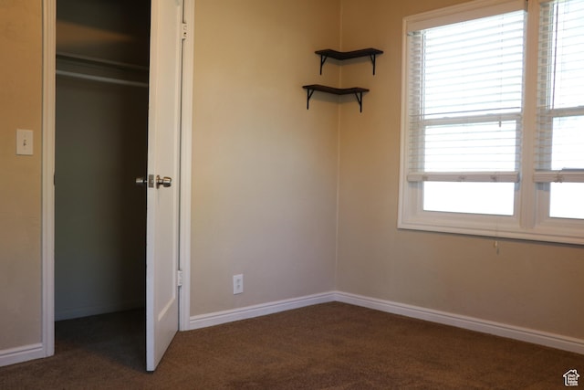 unfurnished bedroom featuring carpet floors and baseboards