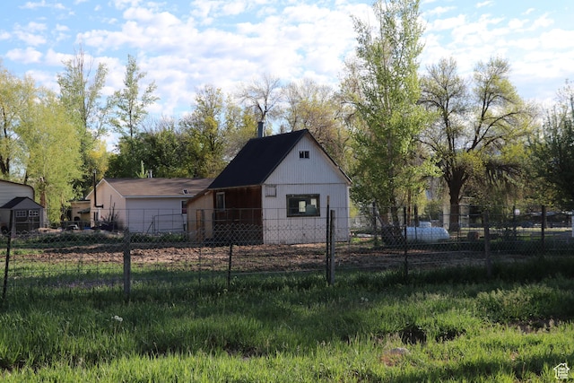 view of outbuilding featuring fence