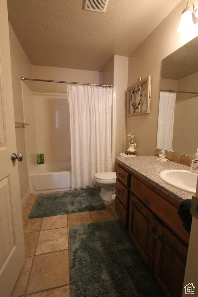 bathroom featuring visible vents, toilet, shower / bathtub combination with curtain, a textured ceiling, and vanity