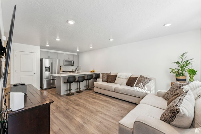 1099 E Quarterdeck Way, Saratoga Springs, UT 84045 - living area with recessed lighting, a textured ceiling, and wood finished floors