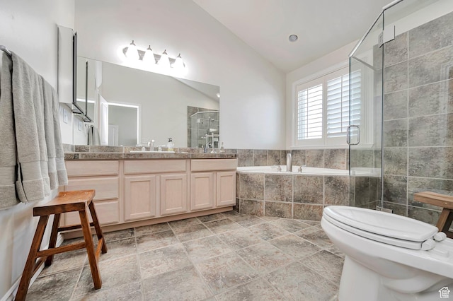 bathroom featuring a garden tub, vaulted ceiling, a stall shower, vanity, and toilet