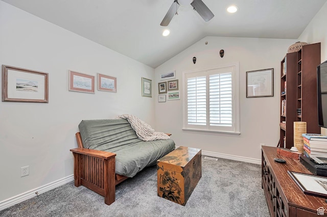 living area featuring carpet floors, a ceiling fan, baseboards, and lofted ceiling