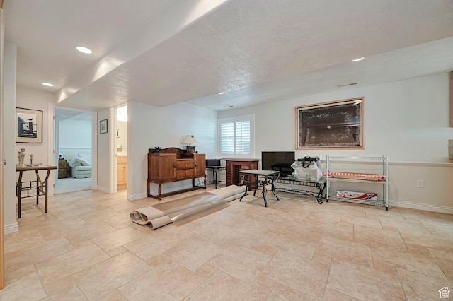 sitting room with recessed lighting, baseboards, visible vents, and stone tile flooring