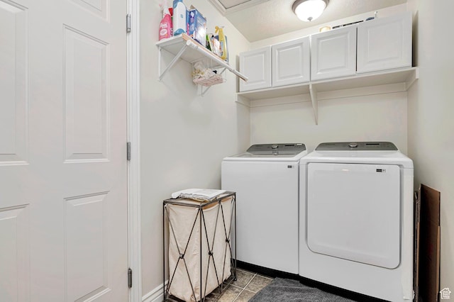 laundry room with cabinet space, independent washer and dryer, baseboards, and light tile patterned floors