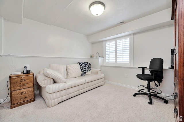 carpeted office space featuring baseboards and visible vents