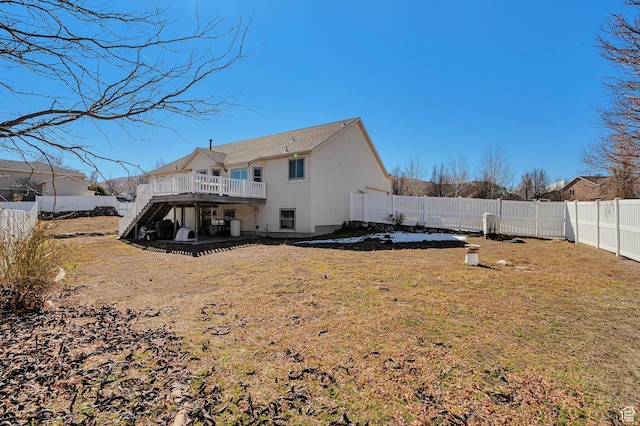 back of house featuring a fenced backyard, stairs, a lawn, and a deck