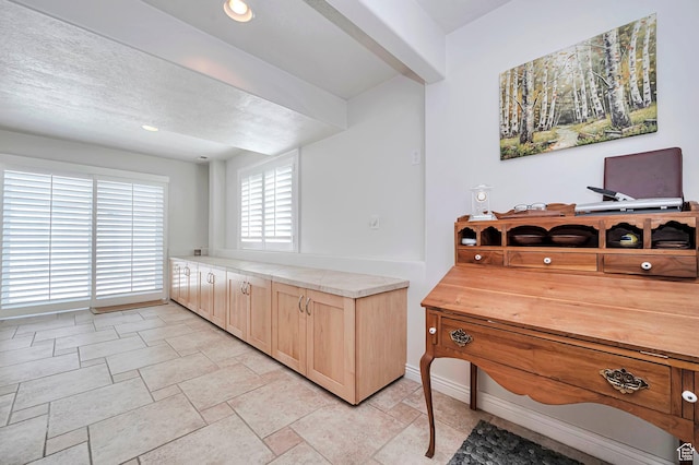 kitchen featuring baseboards and recessed lighting