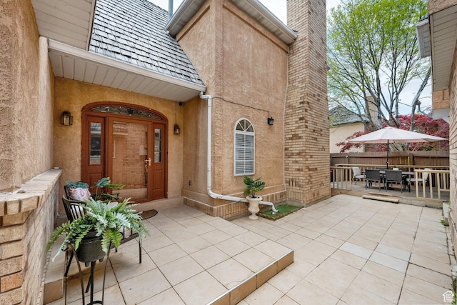 4520 S Countrylane Rd E, Millcreek, UT 84117 - entrance to property featuring outdoor dining area, fence, stucco siding, a patio area, and a chimney