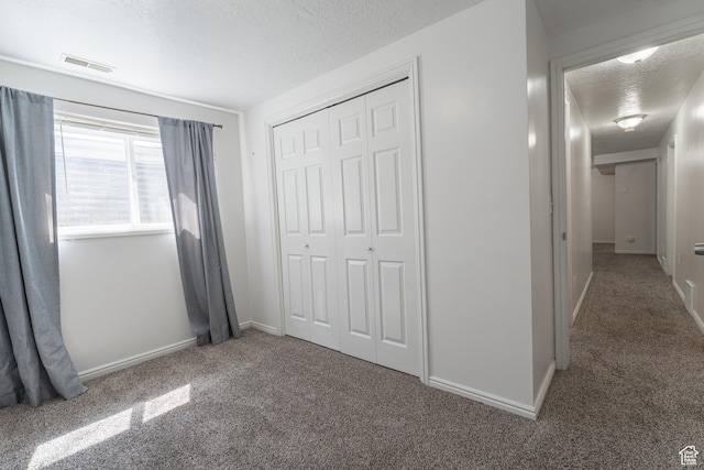 481 E Laurelwood Dr S, Kaysville, UT 84037 - unfurnished bedroom featuring a closet, carpet flooring, a textured ceiling, baseboards, and visible vents