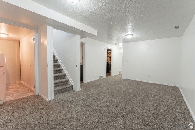 481 E Laurelwood Dr S, Kaysville, UT 84037 - finished below grade area featuring a textured ceiling, visible vents, baseboards, stairs, and carpet floors