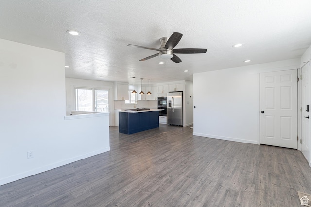 481 E Laurelwood Dr S, Kaysville, UT 84037 - unfurnished living room featuring a ceiling fan, a sink, baseboards, and dark wood finished floors