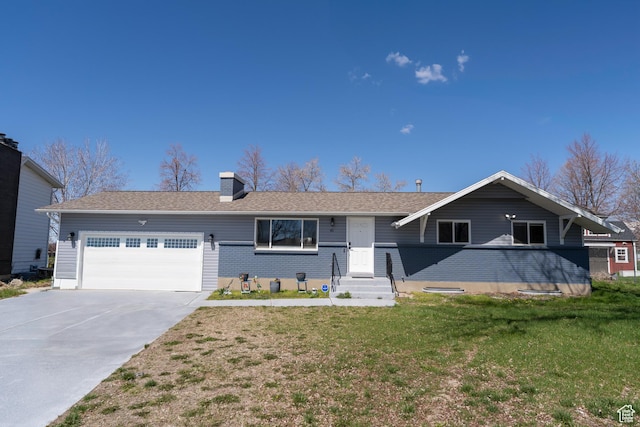ranch-style house featuring a front lawn, driveway, an attached garage, and a chimney