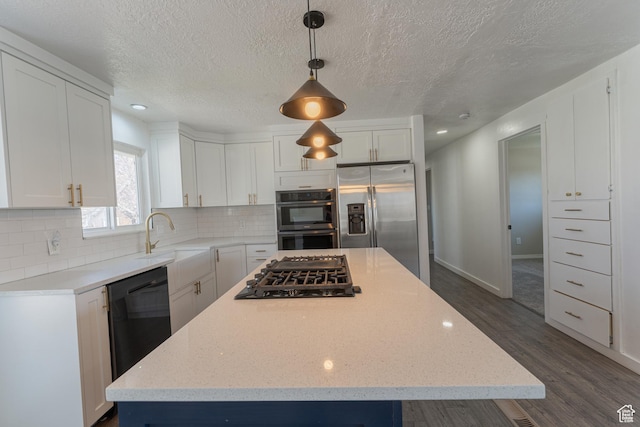 481 E Laurelwood Dr S, Kaysville, UT 84037 - kitchen with white cabinetry, black appliances, a center island, and tasteful backsplash