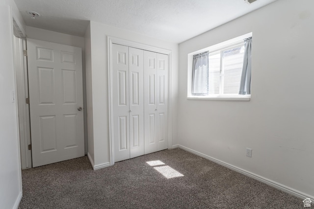 481 E Laurelwood Dr S, Kaysville, UT 84037 - unfurnished bedroom with baseboards, carpet flooring, a textured ceiling, and a closet
