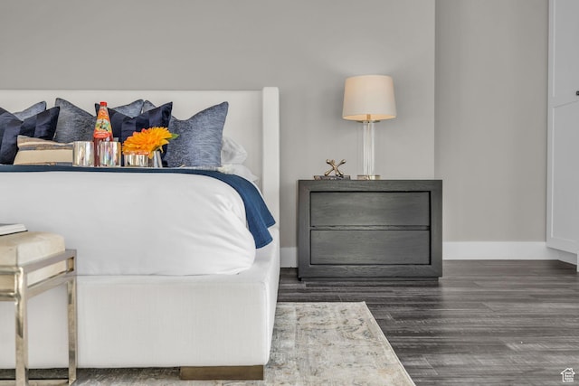 bedroom with baseboards and wood finished floors