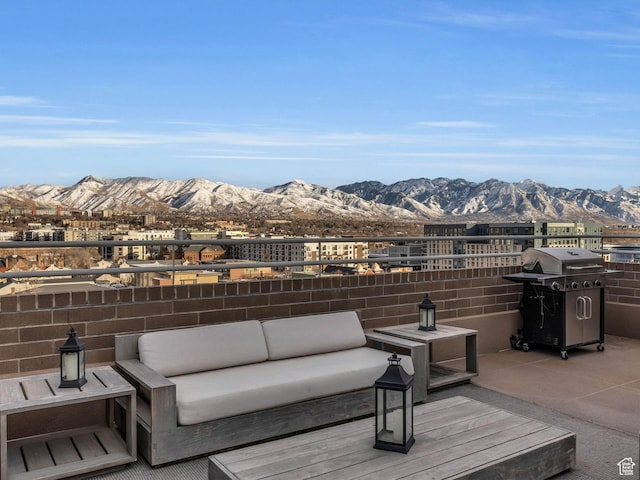 exterior space featuring a mountain view, outdoor lounge area, area for grilling, and a balcony